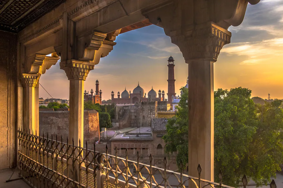 Lahore's Badshahi Mosque seen through a carved archway