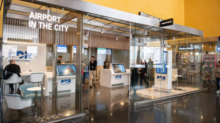 Travellers checking in with luggage at Rome airport